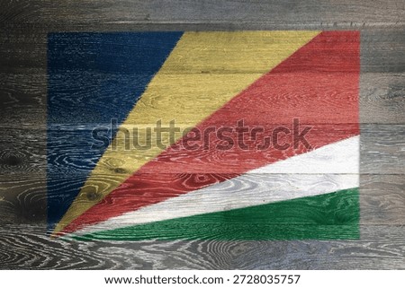 Seychelles flag on rustic old wood surface background