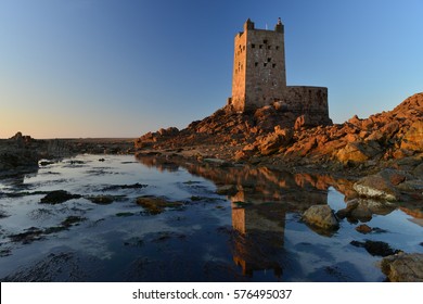 Seymour Tower, Jersey, U.K.  Uninhabited 19th century military building one mile from shore, shot at low tide near sunset.