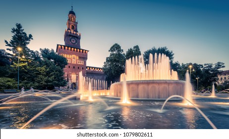 Sforza Castle (Castello Sforzesco) At Night, Milan, Italy. It Is Landmark Of Milan. Panorama Of Old Italian Castle And Luxury Fountain, Scenery Of Milano City. Nice View Of Sforzesco Castel At Dusk.