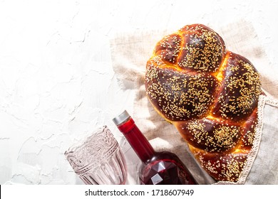 Shabbat or Shabath concept. Challah bread, shabbat wine, top view, copy space. Traditional Jewish Shabbat ritual. Shabbat Shalom.