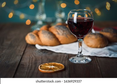 Shabbat Shalom. Challah bread, shabbat wine and candles on the festive background