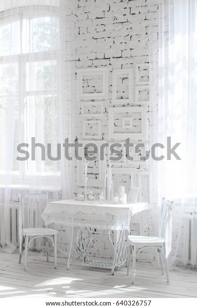 shabby\
chic room interior. Wedding decor, room decorated for shabby chic\
rustic wedding, with bedside table, folding screen or room divider\
with white tracery and rose bouquets. High\
key