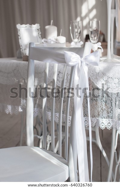 shabby\
chic room interior. Wedding decor, room decorated for shabby chic\
rustic wedding, with bedside table, folding screen or room divider\
with white tracery and rose bouquets. High\
key