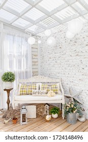 Shabby Chic Spring/Summer Themed Garden Interior With Visually Inviting Architectural Design Elements, White Brick Wall, White Paper Lanterns And Vintage Appeal