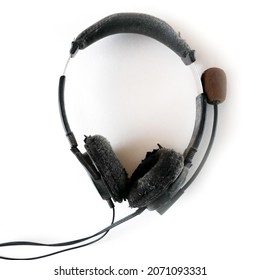 shabby decrepit old headphone isolated on white background, closeup
