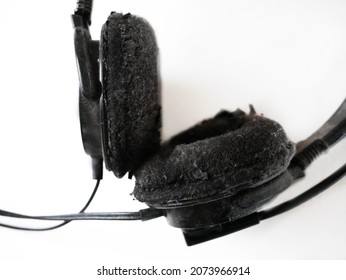 shabby decrepit old headphone isolated on white background, closeup
