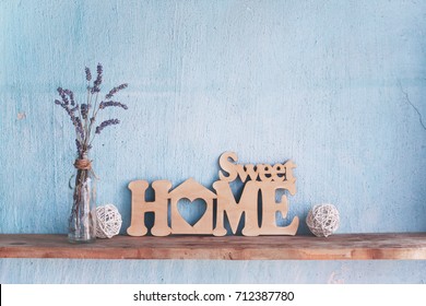 Shabby Old Interior Decor For Farmhouse. Lavender In Glass Vase And Letters: Sweet Home On A Vintage Shelf Over Pastel Wall. Home Decoration.