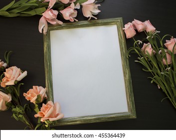 Shabby Photoframe With Pink Roses And Exotic Flowers On Dark Wooden Background. Flat Lay Table Top View With Floral Composition. Backdrop Horizontal Image In Country Style. White Paper With Text Place