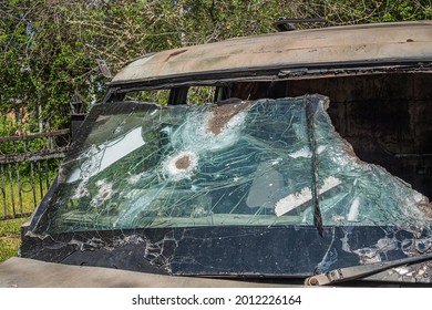 Shabby Weathered Car With Broken Bulletproof Glass After Shooting.