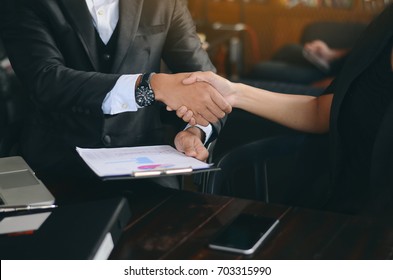 Shack Hand Of Businessman And  Businesswoman, Business People Meeting   Cup Of Coffee On The Table