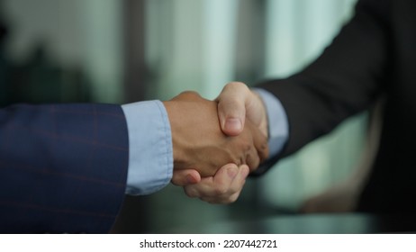 Shacking hands business deal, business people shacking hands together showing successful contract agreement beside secretary business officer clapping hands with gladness city background.