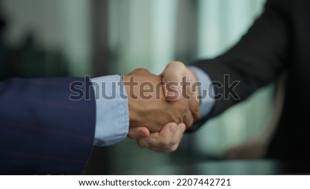 Shacking hands business deal, business people shacking hands together showing successful contract agreement beside secretary business officer clapping hands with gladness city background.