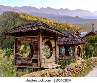 A Shacks In A Noon Time  With Mountains As A Bandground 