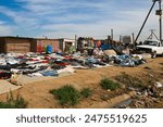 shacks in the slum township in south africa, used clothes market on the side of the road