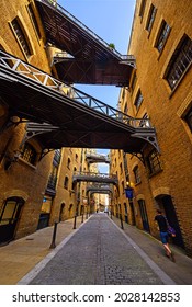 Shad Thames, London, UK - Aug 11 2021: Historic Shad Thames in London near Tower Bridge. This old cobbled street is known for its overhead walkways. Bridges of Shad Thames, Bermondsey, London, UK.