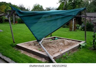 A Shade Of Wooden Poles Fell On The Sandpit In The Family Garden With A Strong Wind And Fallen, Construction, Wooden, Fell, Sandpit, Family, Garden, Strong, Wind, Accident, Tarpaulin, Home, Made, Lawn