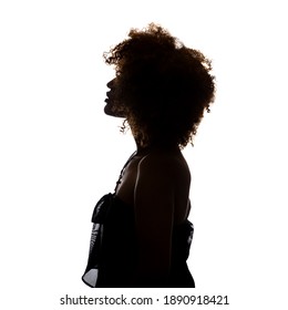 Shaded silhouette of a young African woman against a white background. The woman is standing sideways and you can see her profile.