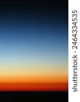 Shades from blue to red of a sunset photographed from an airplane