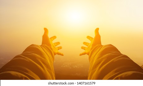 Shadow & blurred photo,A young man prayed for God's blessings with the power and holiness of God on the background of the morning sunrise over the high mountains. God and Spiritual Concepts.