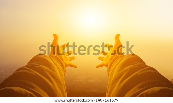 Shadow & blurred photo,A young man prayed\
for God\'s blessings with the power and holiness of God on the\
background of the morning sunrise over the high mountains. God and\
Spiritual Concepts.