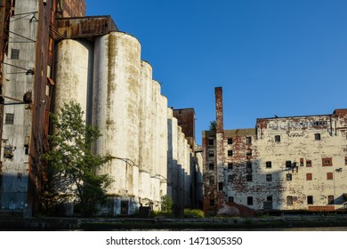 Shadow Is Cast Onto Abandoned Grain Elevators And Silos At The Buffalo NY Waterfront.