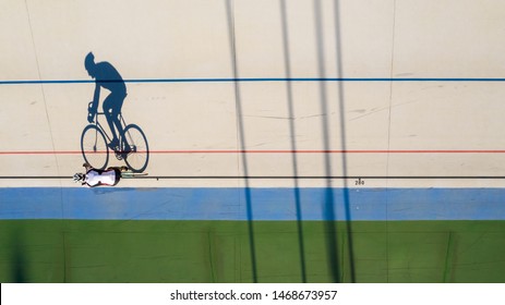 shadow of a cyclist training at a velodrome. preparation for professional competitions. Original shape top view. Sport theme - Powered by Shutterstock