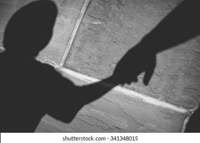 Shadow Of Father Holding Son's Hand In Black And White