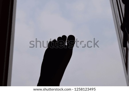 Similar – bare foot at the window