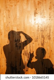 Shadow Of Friend Couple On Yellow Pine Wood Wall With Active Gesture