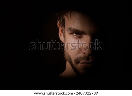 Shadow gangster portrait. Gangster crime young guy. Crime gang members. Crimes style. Man burglar. Angry man. Man with strong body on black in studio. Close up face of brutal gangster.