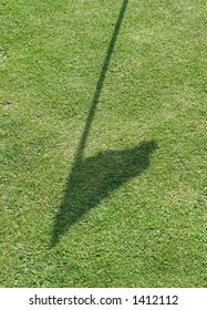 Shadow Of Golf Flag On Grass