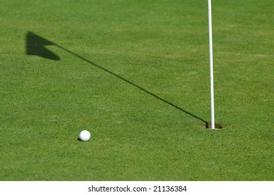 Shadow Of Golf Flag On Green Course