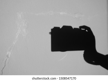 shadow hand holding camera background