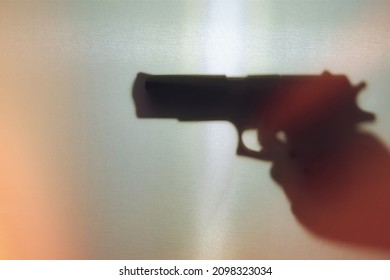 Shadow Of A Hand With A Pistol. Hand Holding A Gun Silhouette