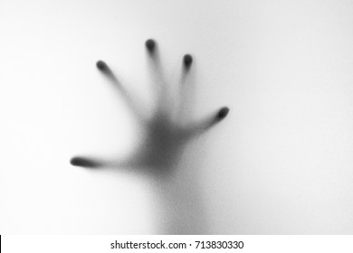 Shadow Of Hand The White Frosted Glass Representing Dangerous, Fear, Help, Horror And Scary.