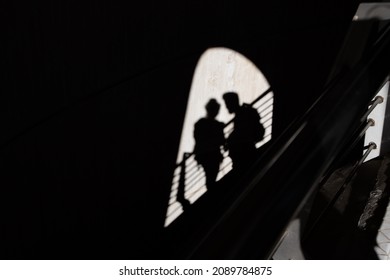 Shadow Of Kissing Couple On Bright Wall In The City