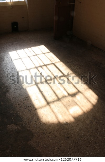 Shadow of a large window from an English\
workhouse. Shadow of a large window of a dormitory from a Georgian\
workhouse in England.