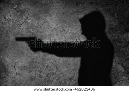 shadow man is aiming with gun