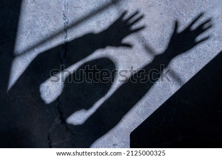 Shadow of a man with hands reaching out