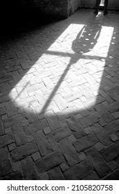shadow of a man standing in front of a large window in a spacious room, loneliness atmosphere