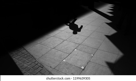 Shadow Of A Man Walking In The City