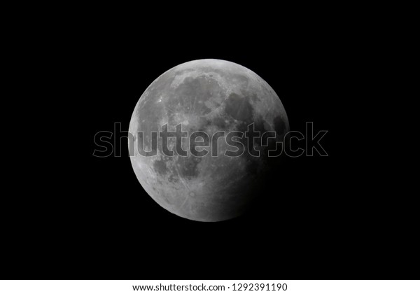 Earth’s shadow is moving off the moon’s surface\
following a total lunar\
eclipse.