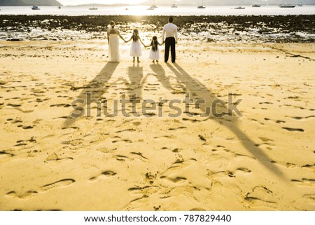 shadow on beach of family look to sea in wedding day.foot print on beach in vintage style.