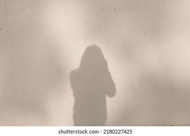 shadow on wall of man with camera