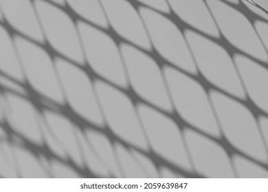 Shadow overlay. Lattice shadow patterned on a white wall on a sunny day
