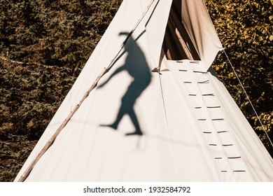 Shadow Of Person Zip Lining On White Tent