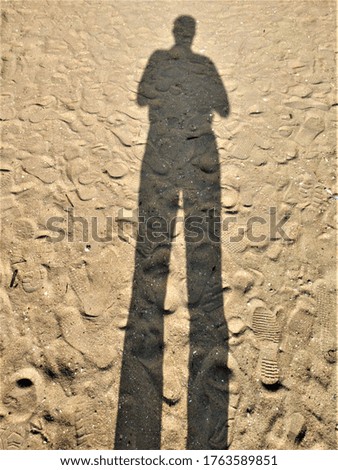 Similar – Shadow of a woman on the beach