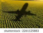 Shadow of the plane on the agricultural field. Concept of decarbonization and biofuel