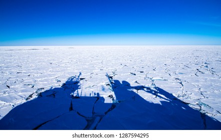 Shadow Of A Polar Research Vessel Over The Frozen Southern Ocean