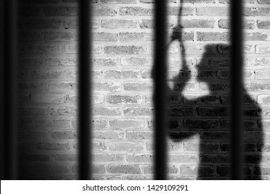 shadow of prisoner man hanging suicide inside the jail. light and shadow
